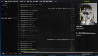 A dark music‑player interface (Tauon Music Box) showing a Hayley Williams artist playlist. The central column lists tracks grouped by album. Right panel shows a monochrome portrait of a woman boxed in orange along with track and album info: Mirtazapine; Ego Death At A Bachelorette Party (2025); In the left sidebar is a list of playlists: Jellyfin Collection; Rediscovered; Xmas Eve 2025; Artist: Hayley Williams. Playback controls are at bottom.