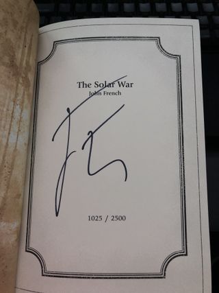 An inside page, featuring the book title and author name, and numbers to indicate this is book 1025 out of the 2500 of this edition that were printed. Across the page is the author's signature.
