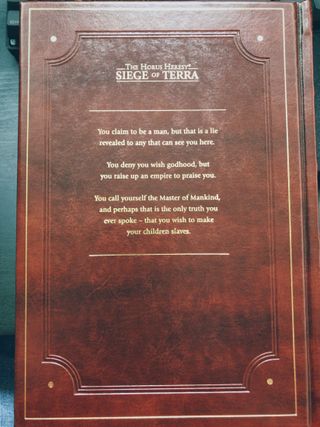 The rear cover of a red leatherbound hardback book. It features embossing and text picked out in gold