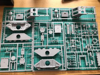 plastic sprues laid out on a cutting mat