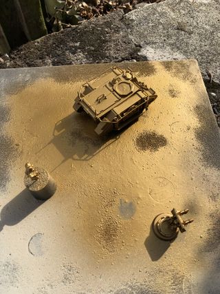 The assembled model, on a wooden board and sprayed with gold primer