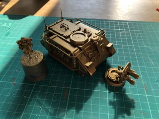 The model arranged in 3 sub assemblies - hull, turret, and gunner - ready for painting