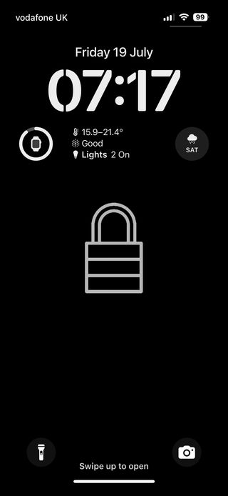A screenshot of an iPhone lock screen.  It features a large digital clock in the upper center, and weather icons. The wallpaper is line art of a locked padlock in light grey centred on the screen, on a black background, as if to indicate the device is locked. The top of the screen displays signal, Wi-Fi, and battery icons, while the bottom has a prompt to swipe up to open.